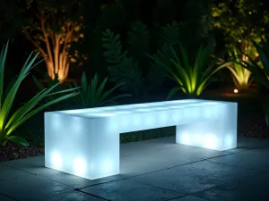 Illuminated Garden Seat - Close-up night shot of a translucent acrylic bench that glows from within, set against dark green tropical foliage and geometric garden lighting