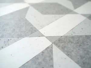 Geometric Pattern Epoxy - Close-up of a modern geometric pattern created in gray and white epoxy flooring, with sharp lines and perfect symmetry