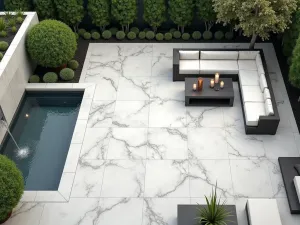 Marble-Effect Porcelain Outdoor Space - Elegant patio featuring white and grey marble-effect porcelain tiles in large format, with a modern water feature and contemporary lounge setting, aerial view