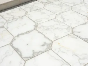 Marble Luxury Terrace - A luxurious patio floor featuring white marble tiles with gray veining in a diamond pattern, close-up showing the stone's natural patterns