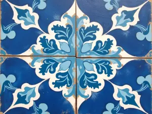 Mediterranean Blue Painted Tiles - Close-up view of a patio floor painted to mimic Mediterranean tiles in shades of cobalt blue and white, with an intricate Moroccan-inspired pattern