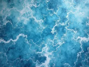 Ocean Blue Metallic - Aerial view of a flowing ocean-blue metallic epoxy floor with white swirls mimicking sea foam