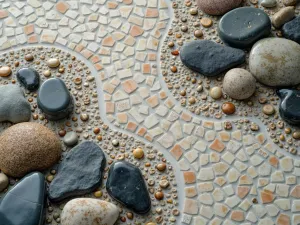 Zen Garden Mosaic - Close-up of a Japanese-inspired mosaic pattern resembling a zen garden, created with small natural stones and ceramic tiles in minimal colors