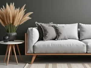 Contemporary Lounge Arrangement - Close-up of a modern sectional sofa with weather-resistant gray fabric, accompanied by geometric side tables and tall ornamental grasses