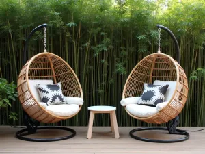 Modern Egg Chair Setup - A pair of contemporary hanging egg chairs with geometric cushions, positioned on a wooden deck with a sleek side table between them, surrounded by tall bamboo plants