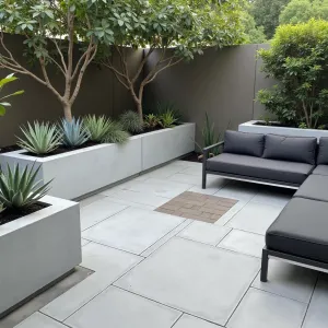 Urban Succulent Paradise - Smooth concrete paver patio in warm grey with geometric inlays. Collection of architectural succulents in modern white planters, including blue chalk sticks and whale's tongue agave. Simple aluminum frame sectional with charcoal cushions.