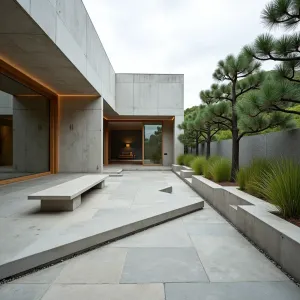 Origami Inspired Haven - Angular concrete patio with folded plane design, featuring geometric concrete walls and built-in benches inspired by origami. Japanese forest grass and cloud-pruned pines in triangular planters complement the architectural elements