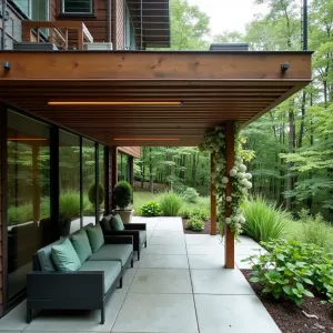 Cantilevered Forest Edge - A modern suspended concrete patio extending from under a wooden deck, creating a floating effect over a woodland garden. Integrated LED strip lighting illuminates the cantilever edge. Japanese forest grass and hostas create a lush understory, while climbing hydrangea softens support posts. Sleek modular furniture in charcoal gray with forest green cushions.