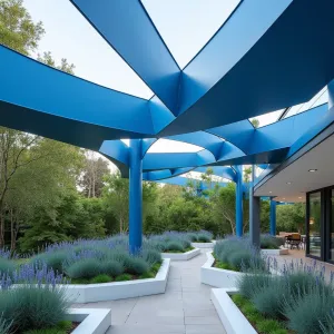 Woven Metal Ribbon Cascade - Interlaced strips of powder-coated aluminum in gradients of blue create a flowing, ribbon-like canopy structure. The garden features Blue Fescue, Russian Sage, and Sapphire Surf Bluebeard in modernist white planters, echoing the overhead color scheme.