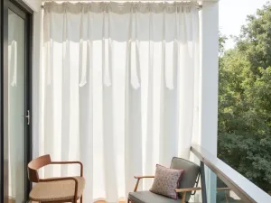 Hanging Shade Curtains - Light, flowing outdoor curtains in white suspended from tension rods, creating adjustable shade on a contemporary apartment balcony