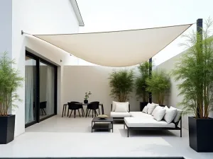 Modern Sail Shade Over Contemporary Patio - A minimalist modern patio with sleek outdoor furniture, covered by a white triangular sail shade, featuring clean lines and geometric patterns, with potted bamboo plants in black contemporary planters